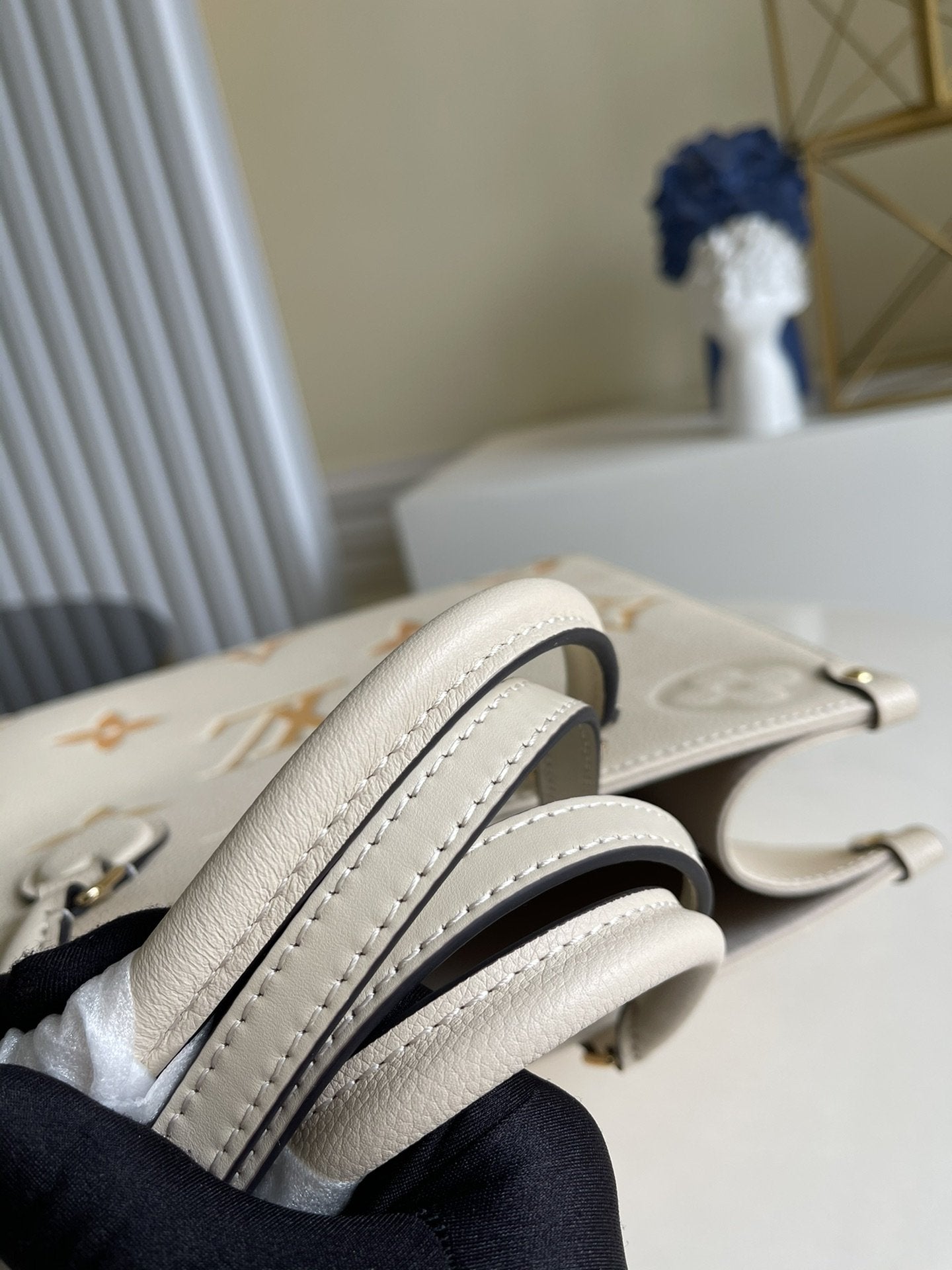 Sac LV Onthego MM 35, garniture en cuir de vachette crème 