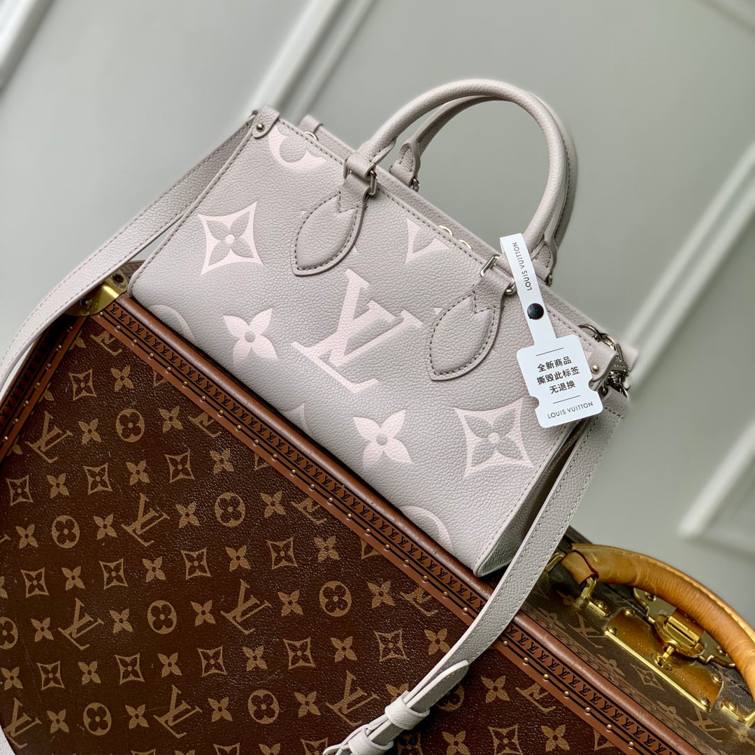 Sac ONTHEGO East West 25 en cuir Empreinte monogrammé bicolore